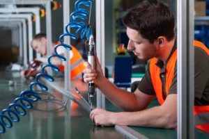 Factory workers and production process with coiled coil hose PU pneumatic tubing