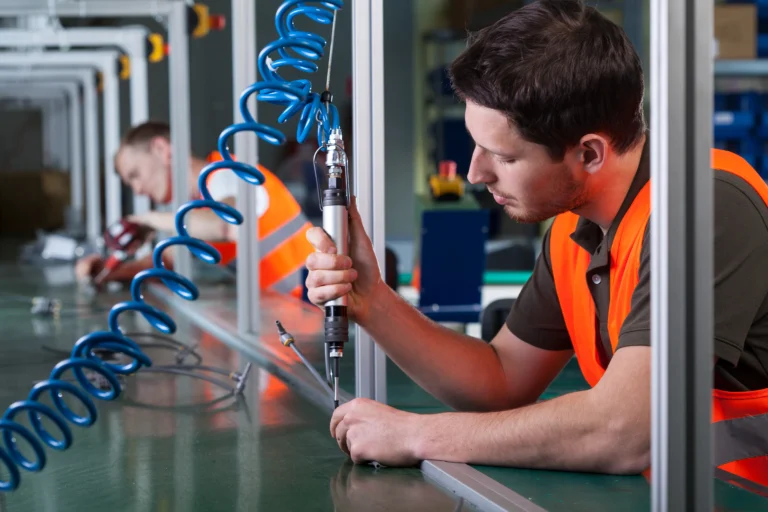 Factory workers and production process with coiled coil hose PU pneumatic tubing